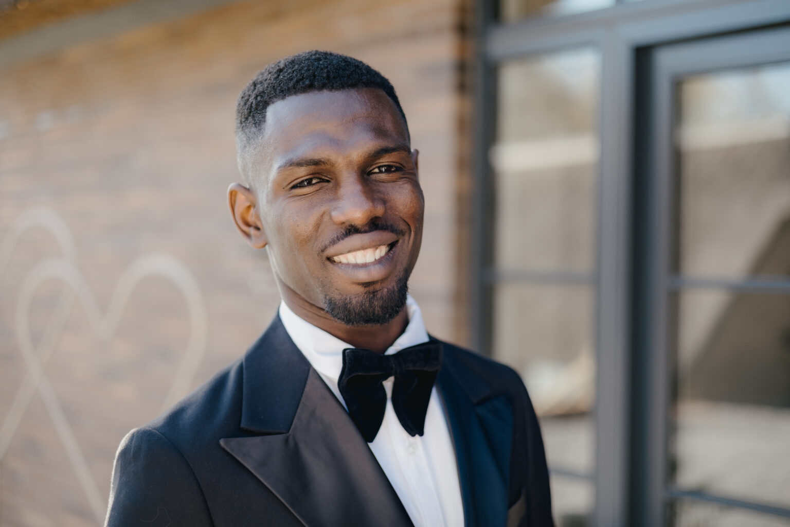 Daniel Osei Afrifa smiling in a black tuxedo